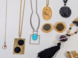 a lot of necklaces that are on a table