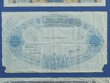 three old french bank notes are displayed on a blue background