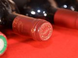 several bottles of wine are lined up on a red table
