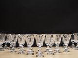 several empty wine glasses are lined up on a wooden table