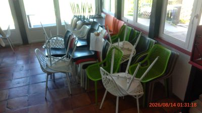 several green and white chairs are lined up in a room
