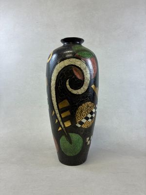 un vase noir avec un motif sur fond blanc
