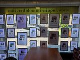 a table in front of a window with pictures on the wall