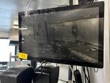 a television that is on a glass shelf in a room
