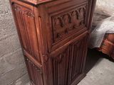 une armoire en bois qui se trouve dans un coin de la pièce