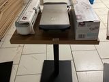 a small table with a printer and a printer on it