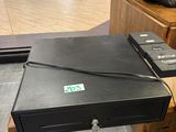 a black box sitting on top of a wooden table