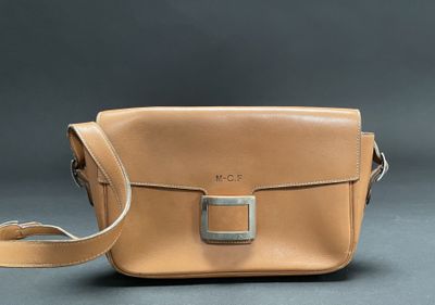 an image of a tan leather bag on a grey background