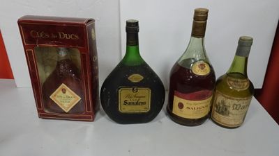 three bottles of liquor sit on a table next to a box of wine