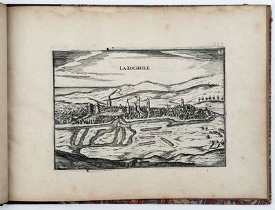 an old book with a drawing of a town in the middle of it