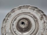 an antique silver plate with a spiral design on it