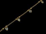 a close up of a gold chain bracelet with blue stones