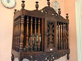 a wooden shelf with a clock on it in a room