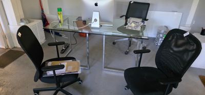 a desk with a chair and a computer on it