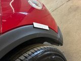 a close up of a red car with a sticker on it