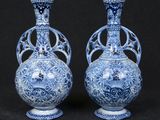 pair of blue and white vases on a black background