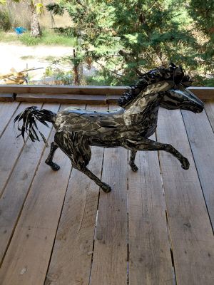 a statue of a horse that is standing on a porch