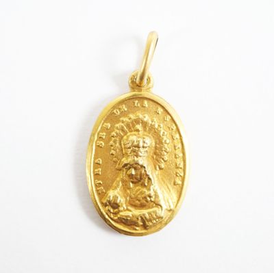a close up of a gold coin with a face of jesus on it
