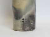 a vase that is sitting on a white surface