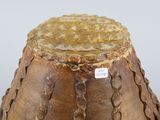 a brown vase that is sitting on top of a table