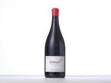 a bottle of red wine sitting on top of a table
