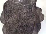 a black object that is sitting on a white surface
