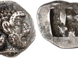 a silver coin with an image of a man and a woman on it
