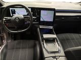 the interior of a car with a laptop on the dashboard