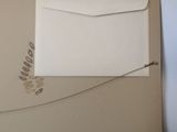 a white envelope sitting on top of a brown box