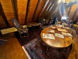 a room with a table, chairs, and a rug in it