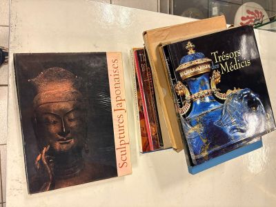 two books that are sitting on top of a refrigerator