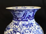 two blue and white vases sitting next to each other