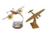 two small metal airplanes sitting on top of each other