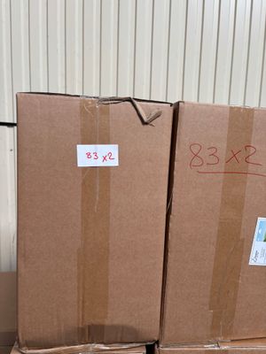 cardboard boxes stacked on top of each other in a warehouse