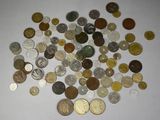 a pile of coins on a table with a white background
