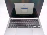 a laptop computer that is open on a white surface