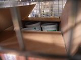 a bird in a cage that is filled with food