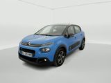 a blue citrole is parked in a white room