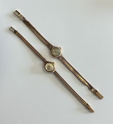 a pair of ladies ' s wrist watches on a white surface