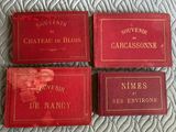 three red books sitting on top of a bed next to each other
