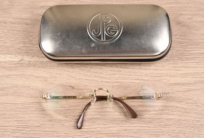 a pair of glasses sitting on a table next to a case