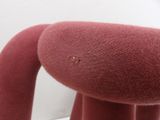 a red stuffed animal that is sitting on a table