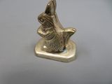a small statue of a dog sitting on a plate