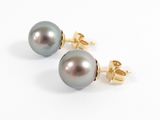 a pair of black pearl earrings on a white background