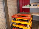 a yellow and red cart sitting in the middle of a room