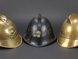 three different types of helmets sitting on top of a black surface