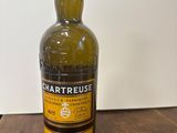 an empty bottle of whisky sitting on a wooden table