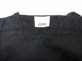 the back of a black shirt with a white label on it