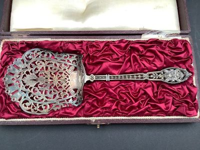 a silver spoon in a red box on a black table