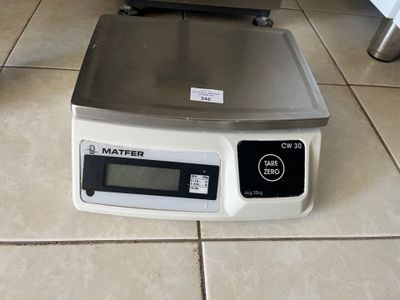 a scale that is on the floor next to a bowl